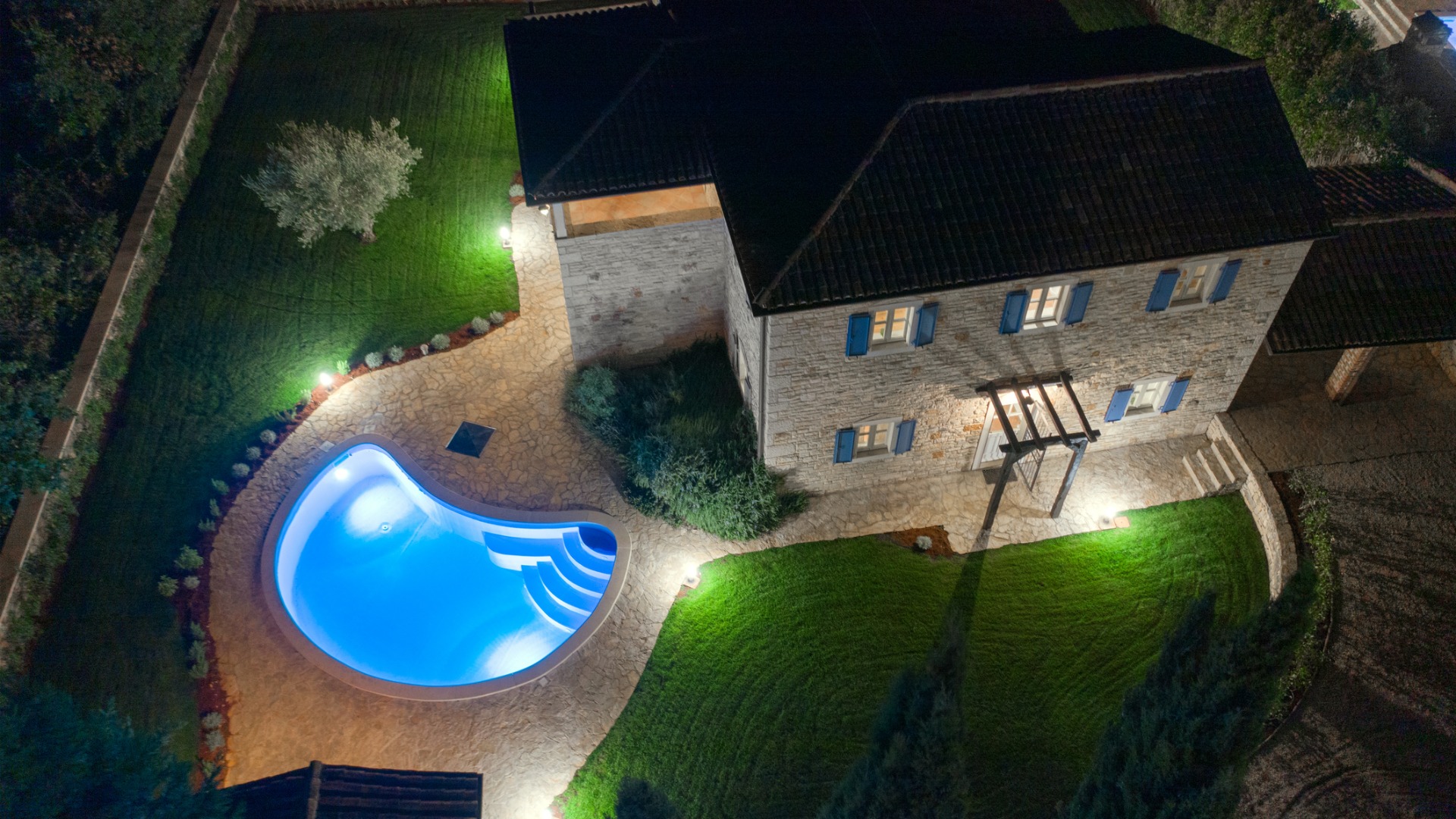 An aerial view of a home with beautiful Landscape Lighting in Peoria IL