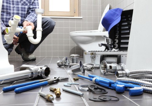 A plumber installing a toilet, as part of residential plumbing services in Central Illinois