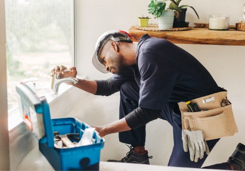 A plumber in Central Illinois fixing a leaky faucet