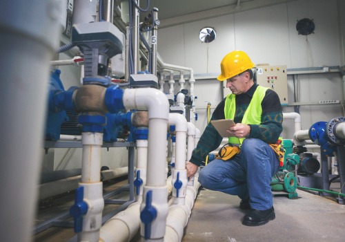 A plumber working on a business's water system, part of commercial plumbing in Central IL