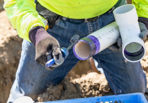 A worker preparing a pipe for installation as part of an underground water line for Commercial Plumbing in Bloomington IL