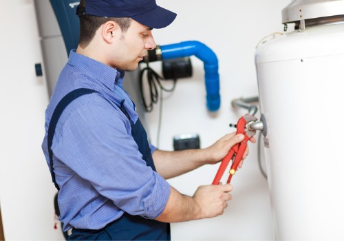 Technician repairing a water heater, part of Plumbing Services offered in Bloomington IL