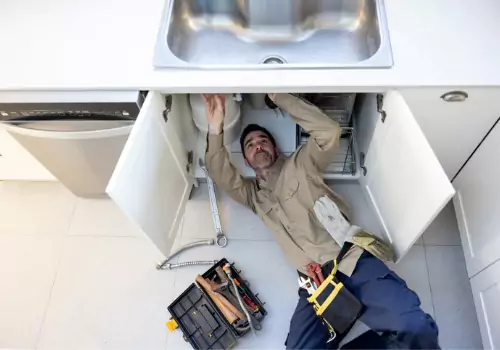 A plumber is seen at work. TCI Plumbing are Plumbers in Morton IL