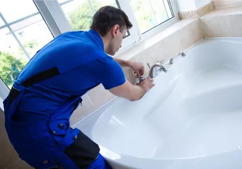 A plumber is seen at work. TCI Plumbing is a Bloomington Plumber.