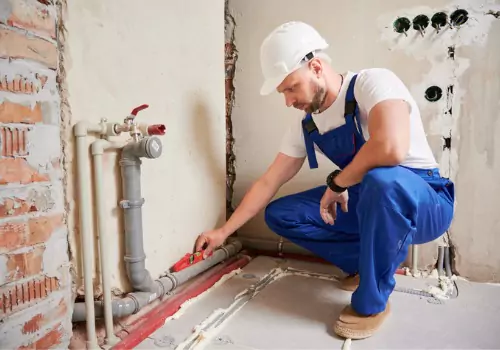 A plumber is seen at work. TCI Plumbing performs same day plumbing service in Peoria IL.