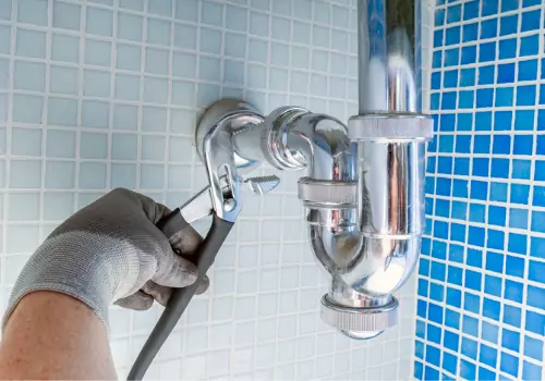 A plumber is seen at work. TCI Plumbing is a Bloomington Plumber.