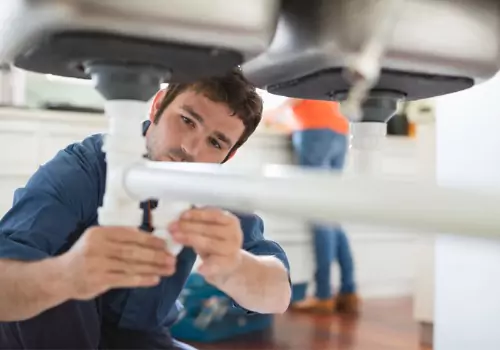 A plumber is seen at work. TCI Plumbing performs same day plumbing service in Peoria IL.