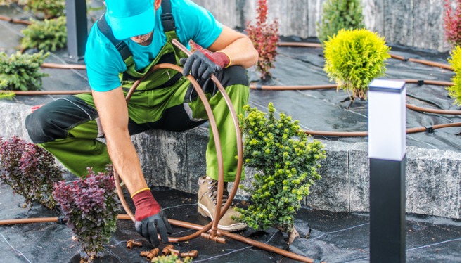 A professional member of TCI Companies performs irrigation installation at a home in Central Illinois.