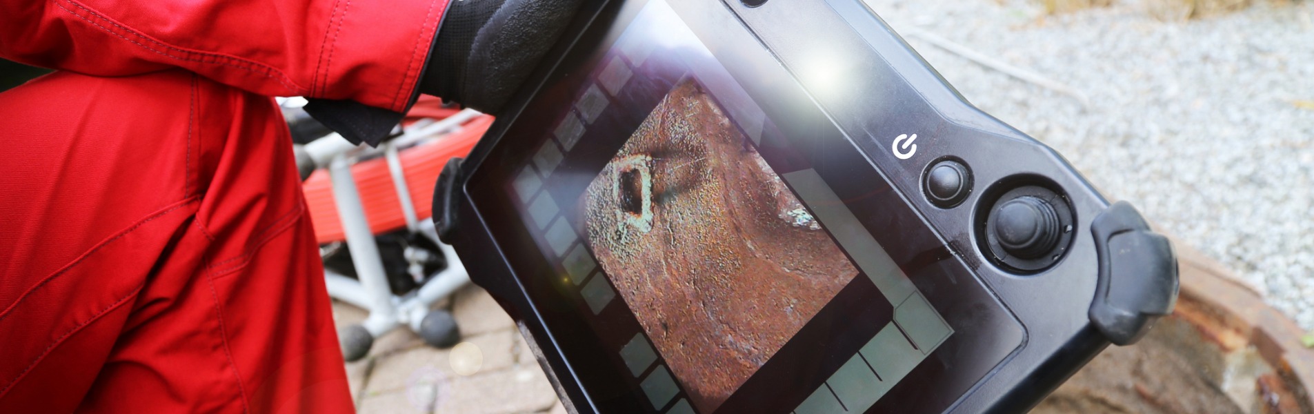 A team member from TCI Companies performs a sewer inspection with a camera to determine if the job needs sewer lining solutions.