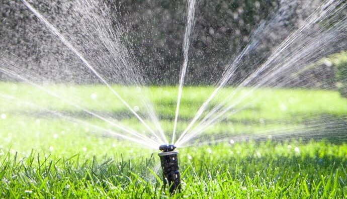 A lawn sprinkler operating at full capacity, thanks to the plumbing & utility services offered by TCI Companies